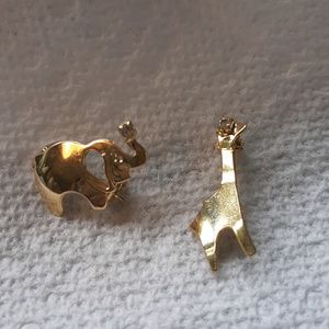 Two gold toned pins one giraffe, one elephant